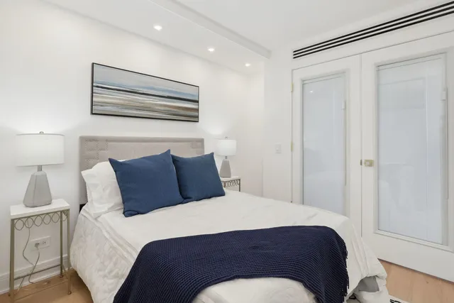 a large bed sitting in a bedroom next to a cabinet