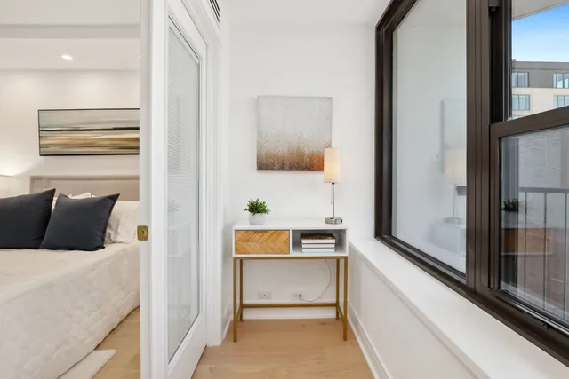 a bedroom with a bed and a lamp