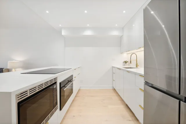a kitchen with a sink stove and microwave