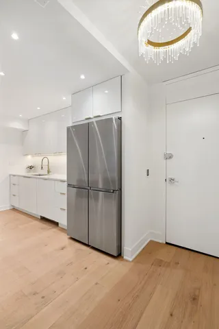 a view of a kitchen with a sink and a refrigerator