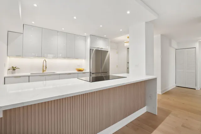 a kitchen with refrigerator and a sink