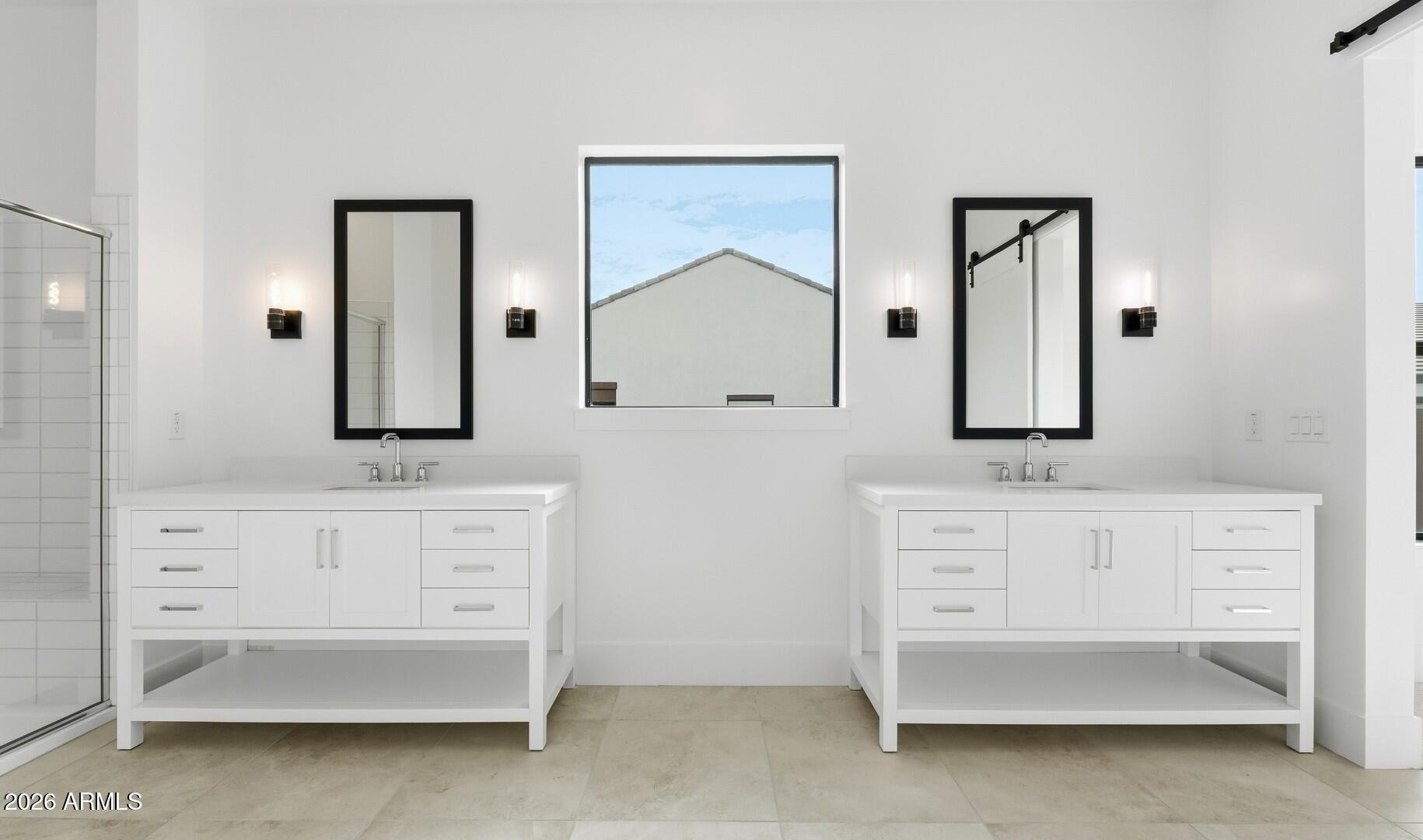 663 East Grayling Road San Tan Valley, AZ 85140 - Photo 24 of 31 a bathroom with double vanity sink a two mirror a window and glass door