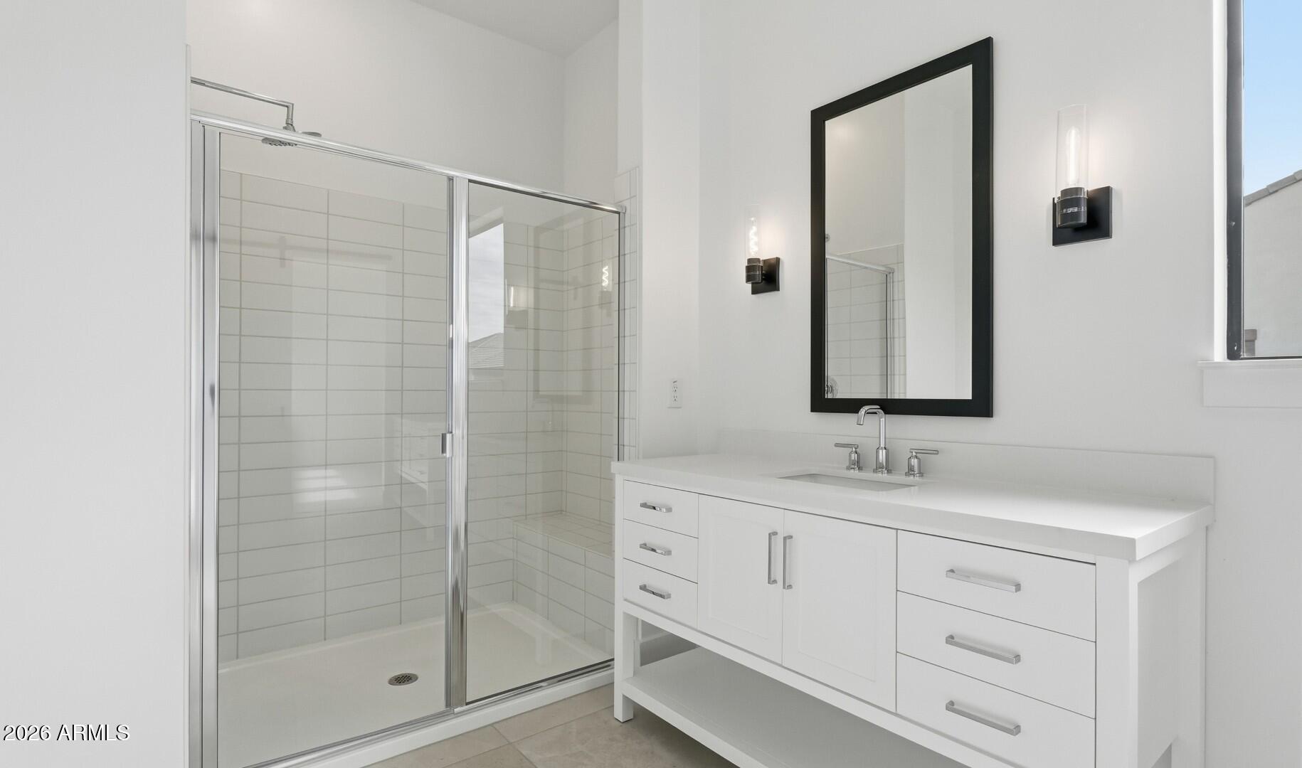 663 East Grayling Road San Tan Valley, AZ 85140 - Photo 26 of 31 a bathroom with a shower sink and mirror