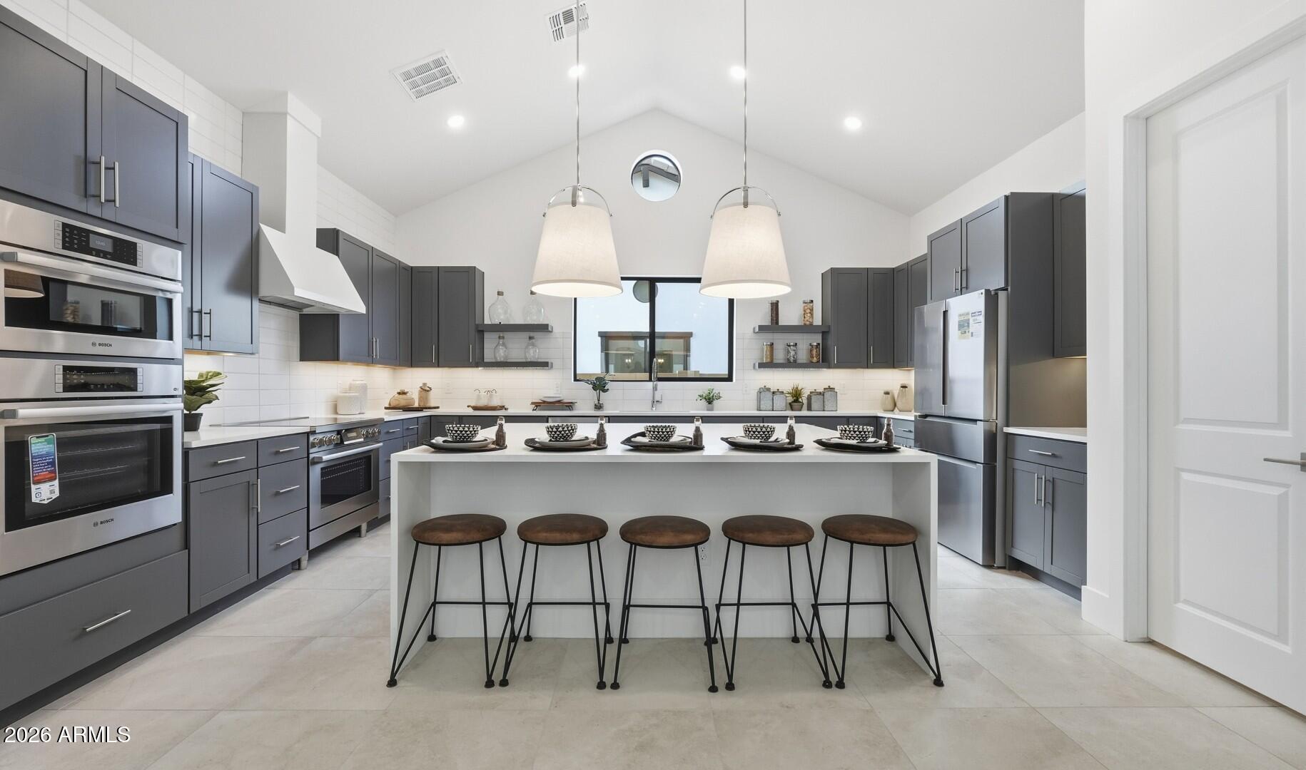 663 East Grayling Road San Tan Valley, AZ 85140 - Photo 2 of 31 a large kitchen with a large counter top stainless steel appliances and cabinets