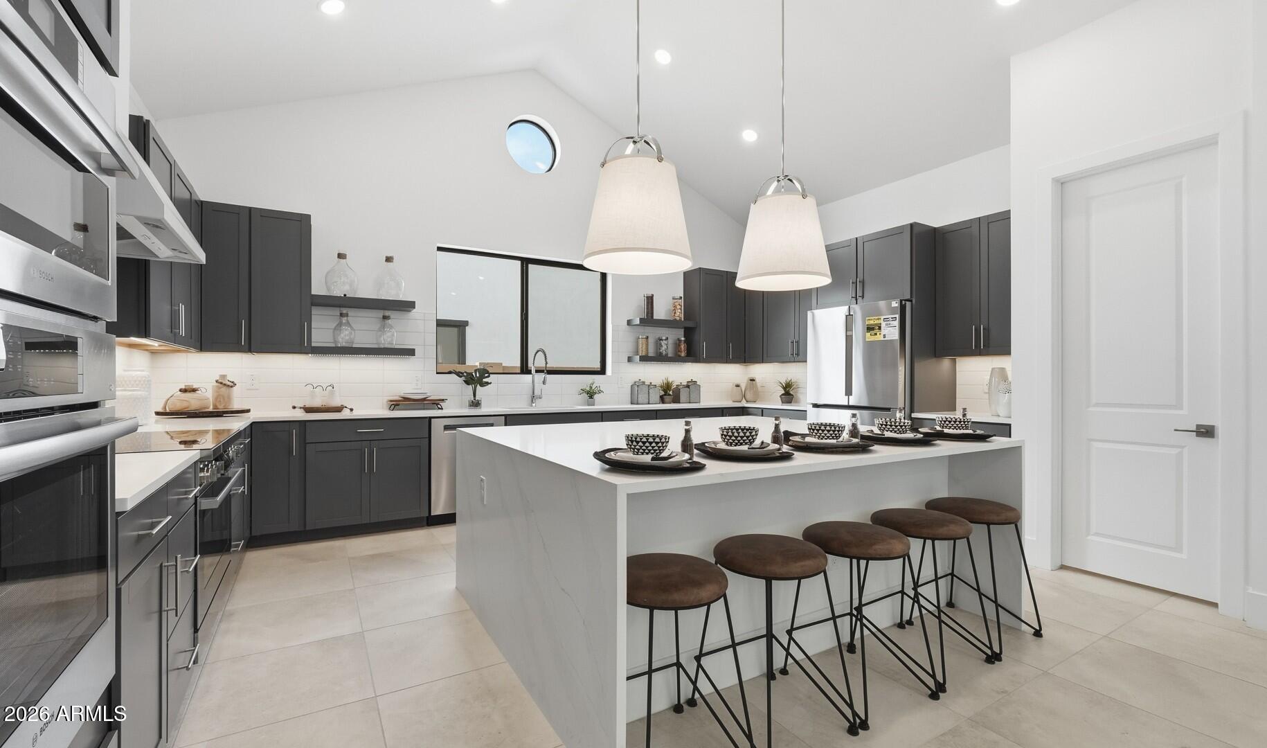 663 East Grayling Road San Tan Valley, AZ 85140 - Photo 3 of 31 a kitchen with a sink and chairs