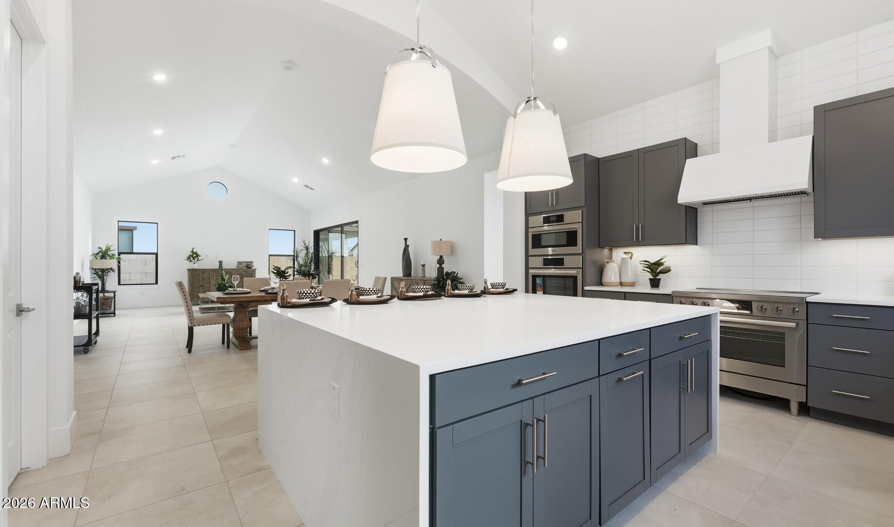 663 East Grayling Road San Tan Valley, AZ 85140 - Photo 4 of 31 a kitchen with a sink a stove and chairs