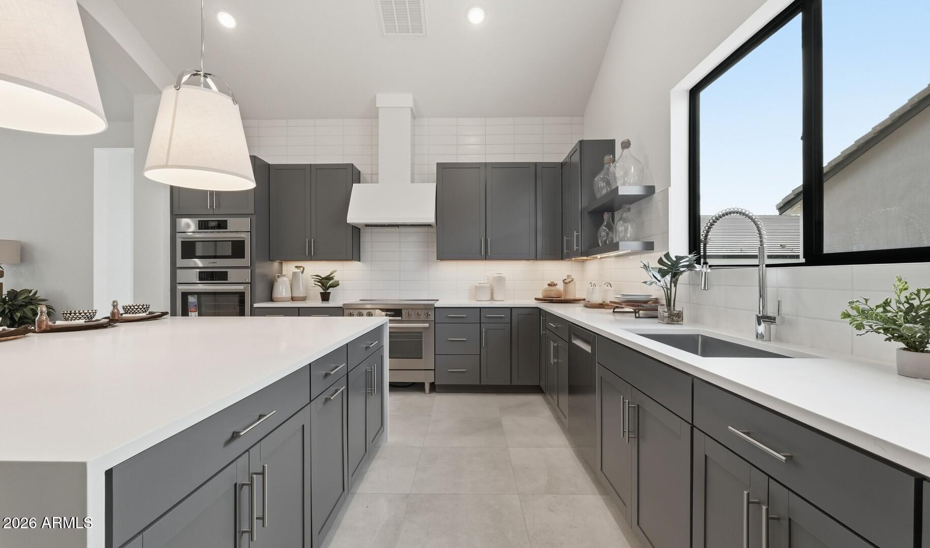 663 East Grayling Road San Tan Valley, AZ 85140 - Photo 5 of 31 a kitchen with stainless steel appliances a sink stove and cabinets
