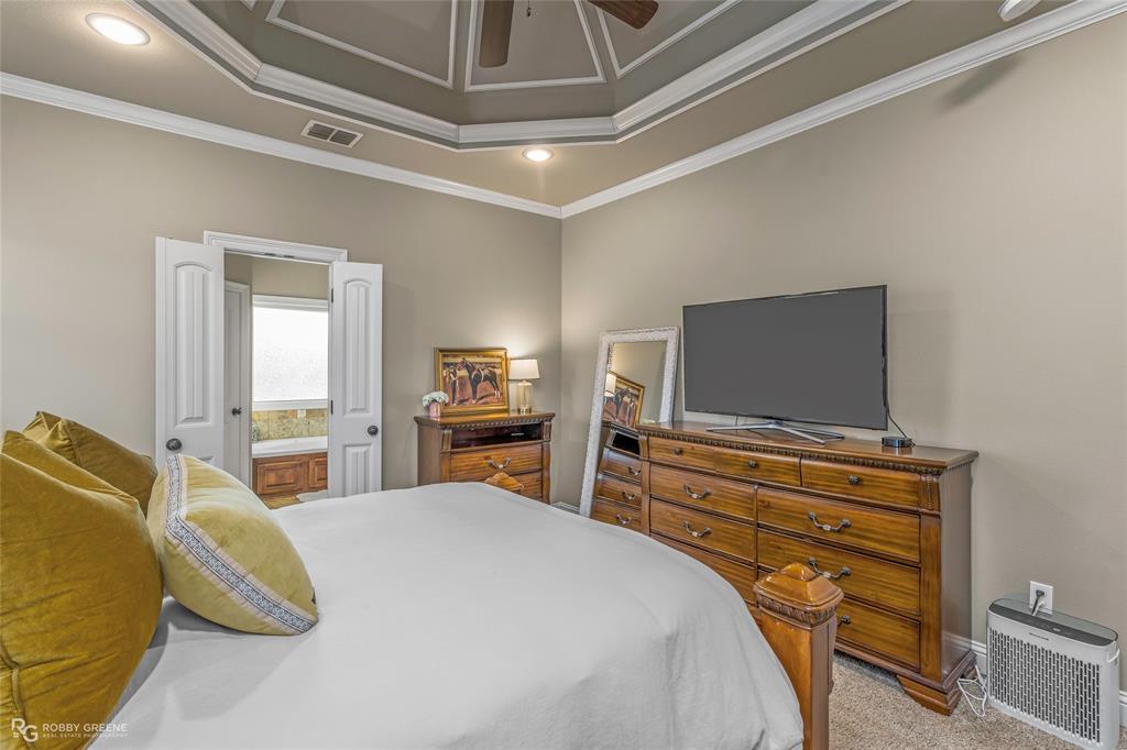 3034 Sagefield Lane Haughton, LA 71037 - Photo 14 of 28 a bedroom with a bed and flat screen tv