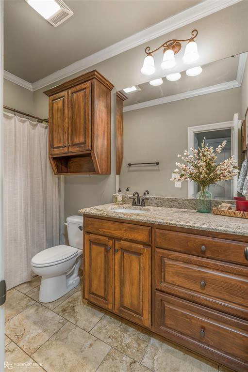 3034 Sagefield Lane Haughton, LA 71037 - Photo 21 of 28 a bathroom with a granite countertop sink a toilet and a mirror