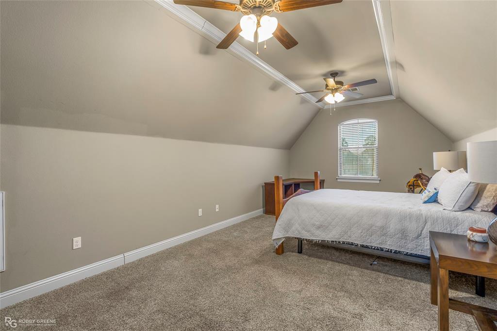 3034 Sagefield Lane Haughton, LA 71037 - Photo 22 of 28 a spacious bedroom with a bed and a chandelier