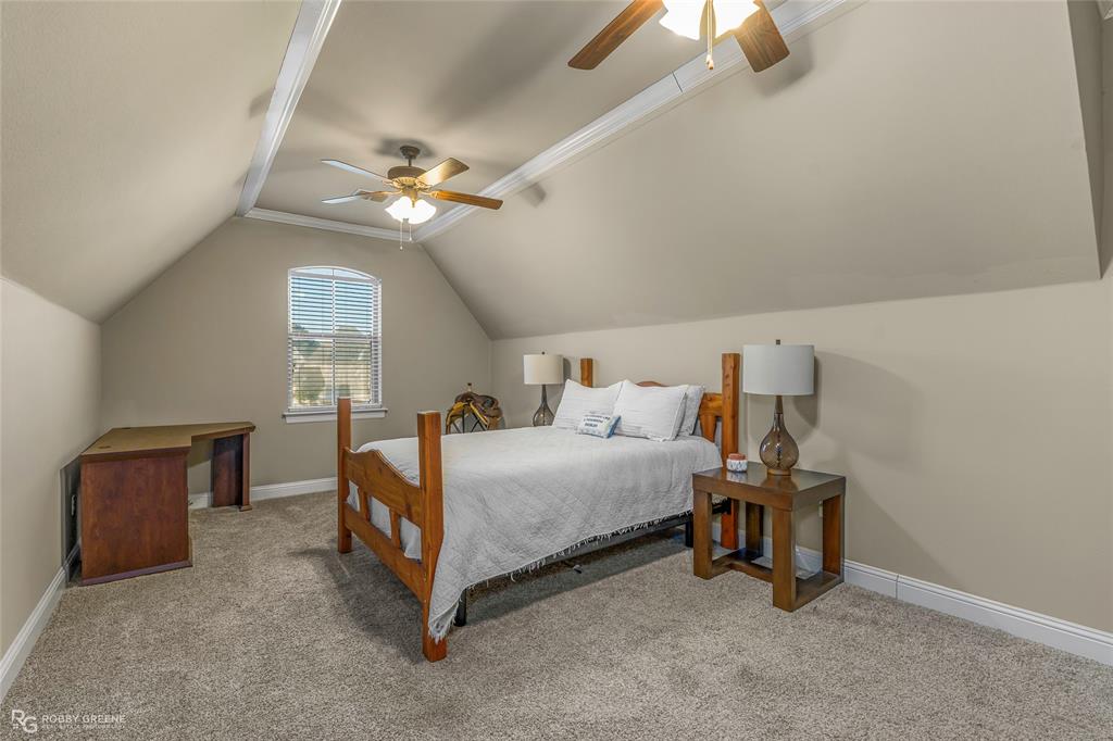 3034 Sagefield Lane Haughton, LA 71037 - Photo 23 of 28 a bedroom with a bed and a chandelier