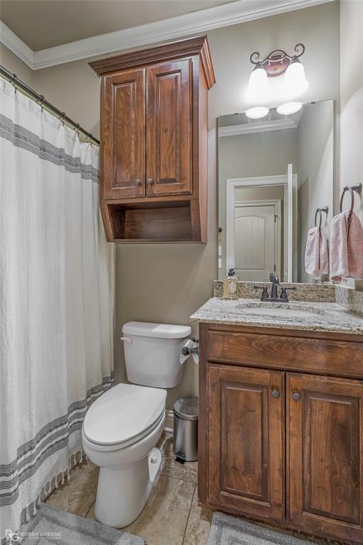 3034 Sagefield Lane Haughton, LA 71037 - Photo 24 of 28 a bathroom with a granite countertop toilet a sink a vanity and mirror