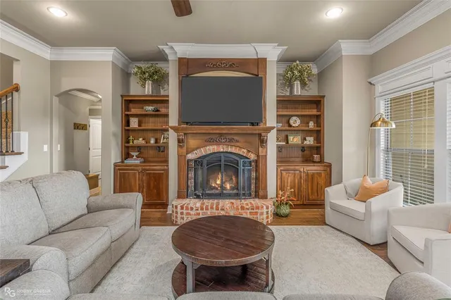 a living room with furniture a rug and a fireplace