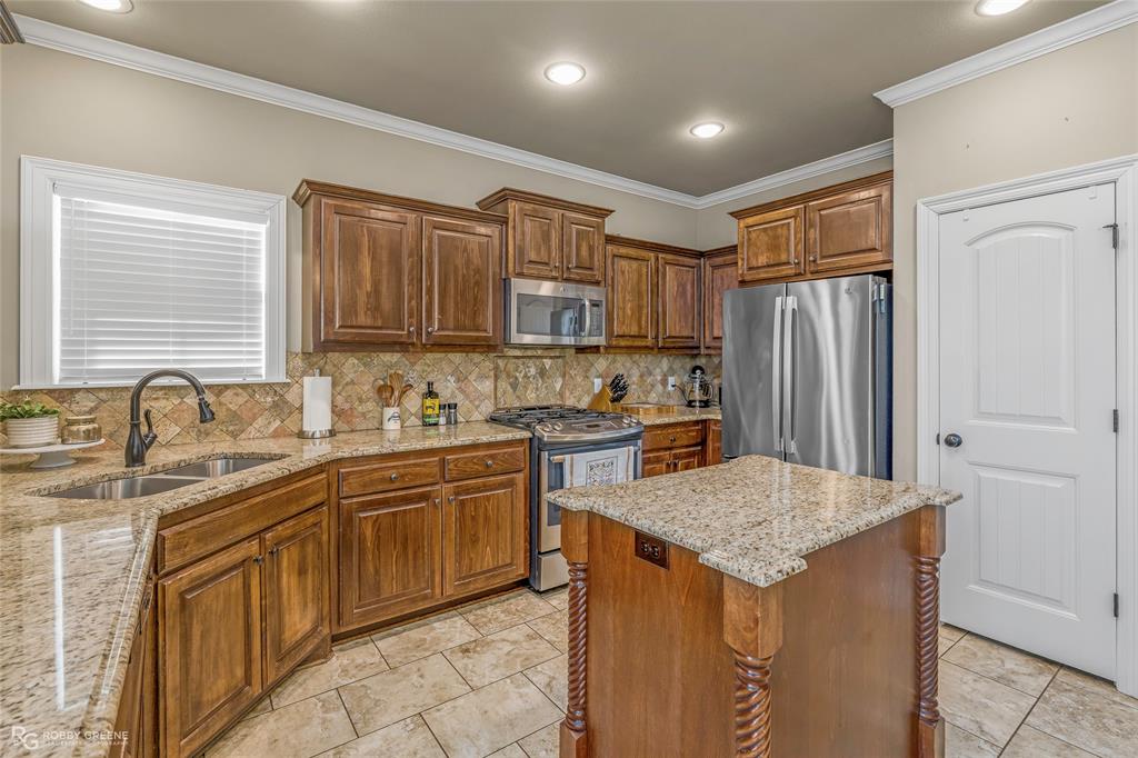 3034 Sagefield Lane Haughton, LA 71037 - Photo 9 of 28 a kitchen with stainless steel appliances granite countertop a sink stove and refrigerator