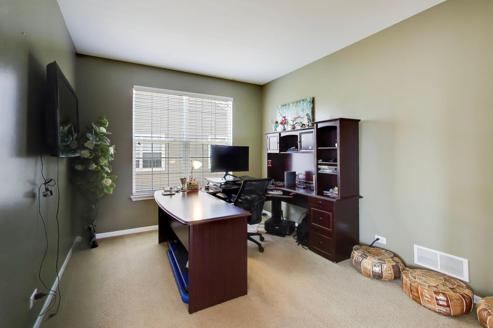 343 Copper Springs Lane Elgin, IL 60124 - Photo 16 of 50 a room with furniture a flat screen tv and a window