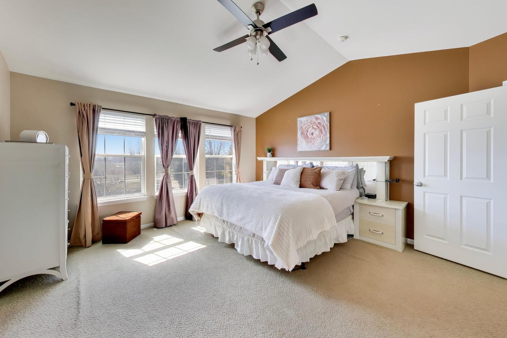 343 Copper Springs Lane Elgin, IL 60124 - Photo 21 of 50 a bedroom with a large bed and a chandelier