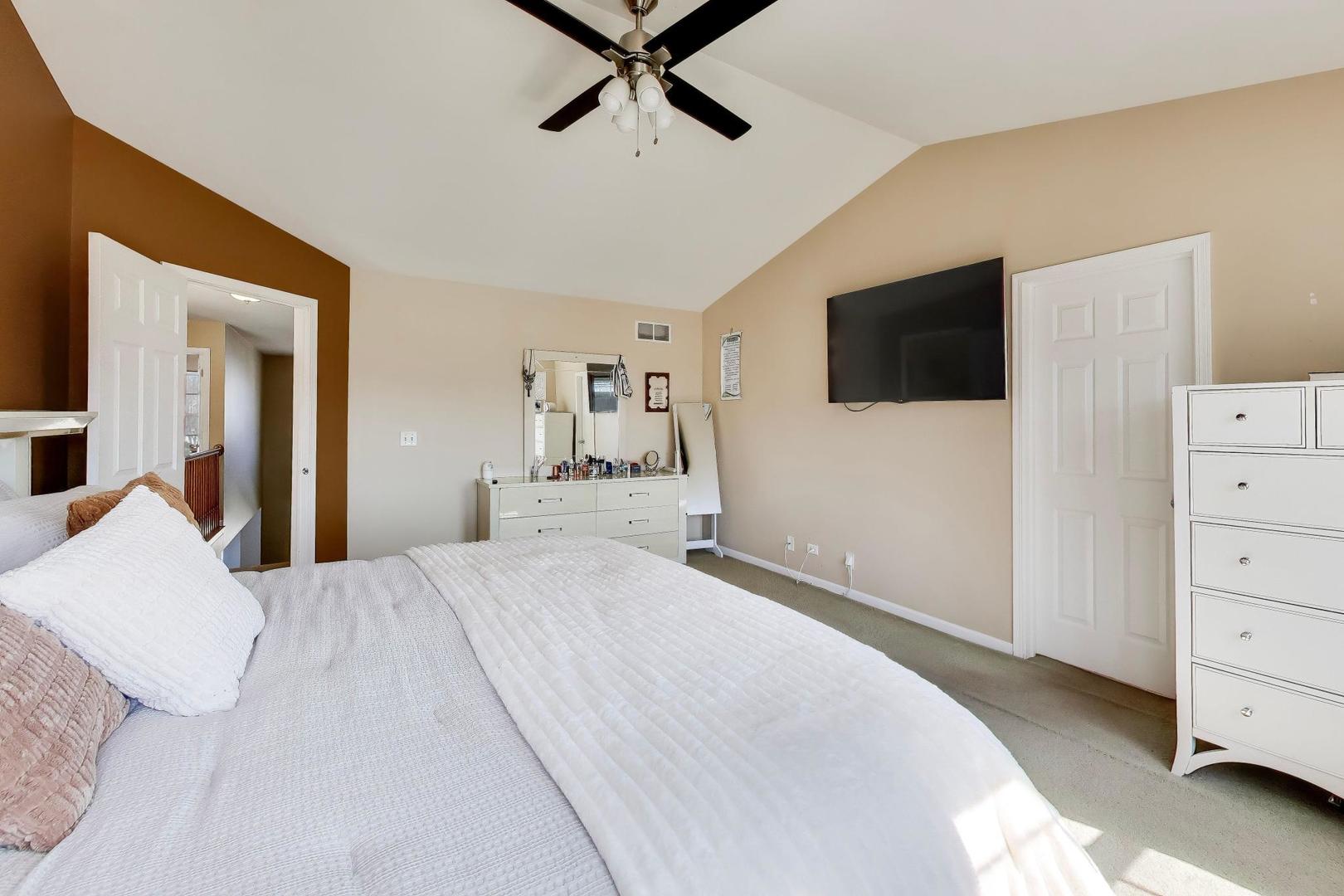 343 Copper Springs Lane Elgin, IL 60124 - Photo 22 of 50 a bedroom with a bed and a flat tv screen on dresser