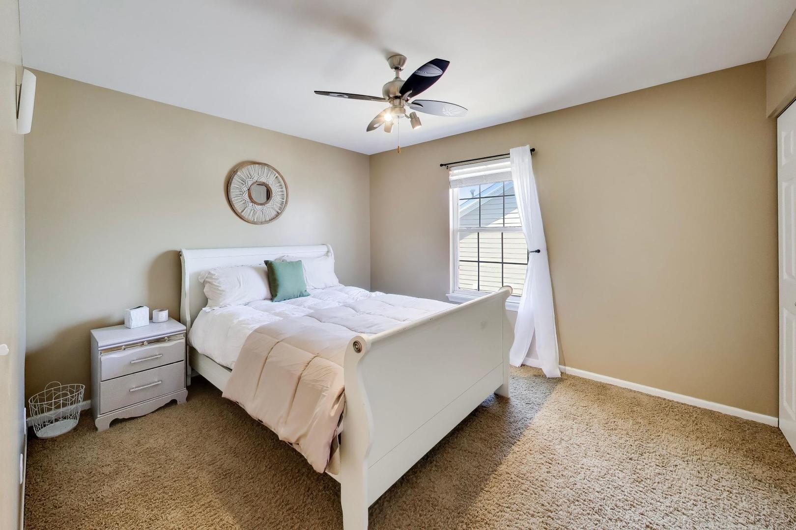 343 Copper Springs Lane Elgin, IL 60124 - Photo 25 of 50 a bed room with a bed and a ceiling fan