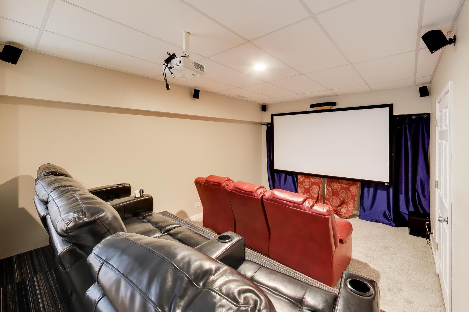 343 Copper Springs Lane Elgin, IL 60124 - Photo 29 of 50 a projector room with two couches and a projector screen