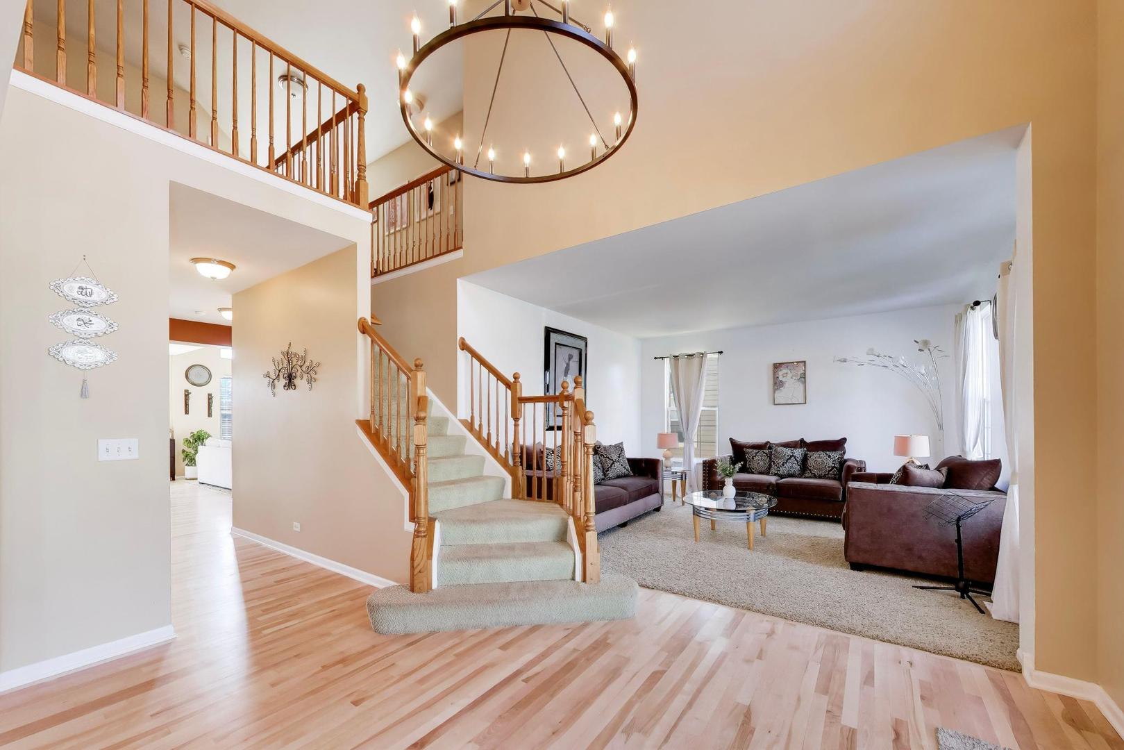 343 Copper Springs Lane Elgin, IL 60124 - Photo 5 of 50 a living room with furniture and a chandelier