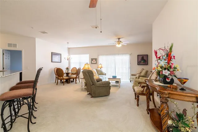 a living room with furniture and flowers