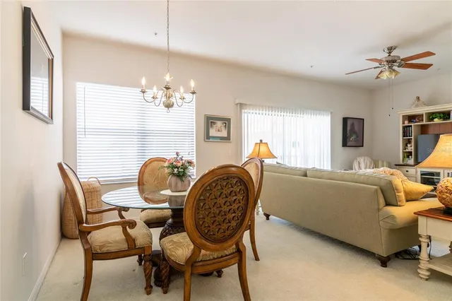 a living room with furniture a chandelier and a window