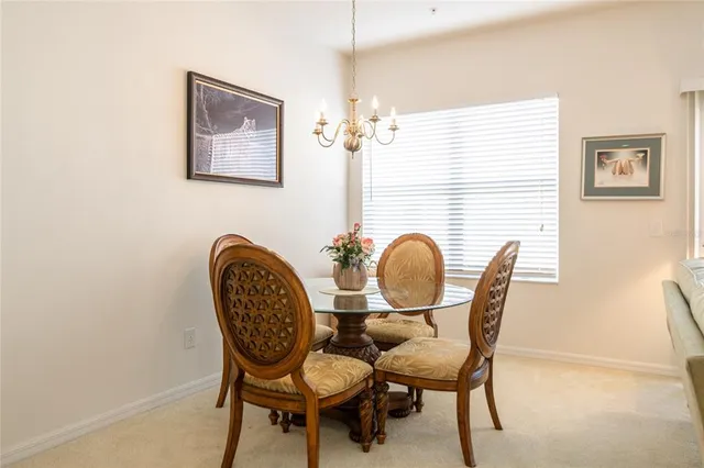 a view of a dining room with furniture and chandelier