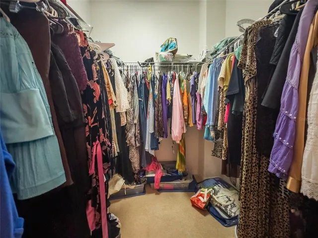 a view of walk in closet with clothes