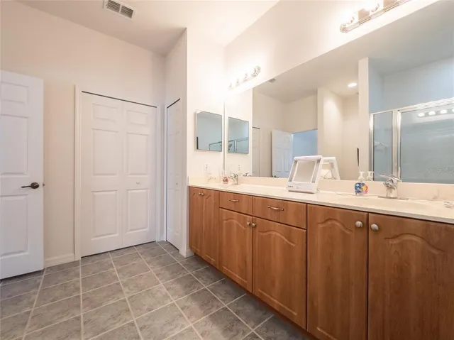 a bathroom with a double vanity sink and a mirror