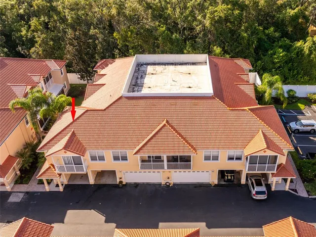 an aerial view of a house with a yard and balcony