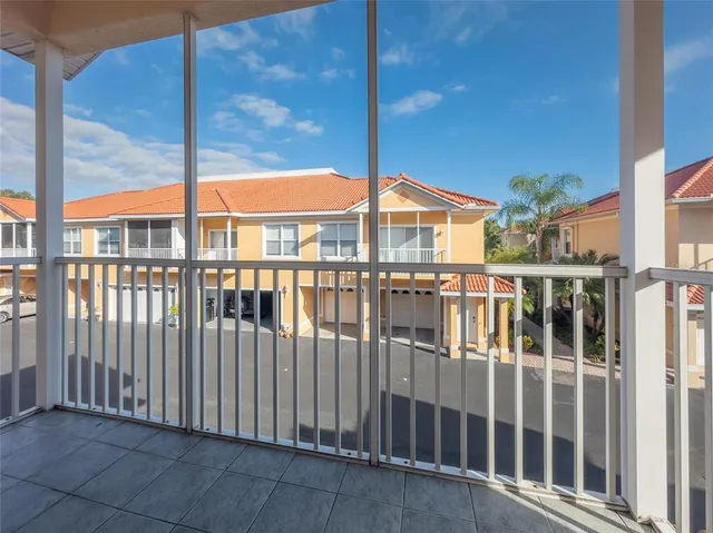 a view of a balcony with a floor to ceiling window and wooden fence