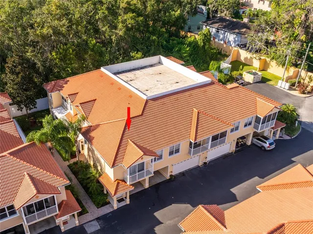 a view of a house with pool and chairs