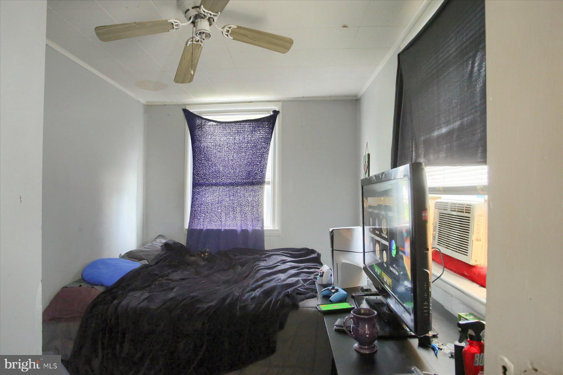 46 Front Street New Buffalo, PA 17069 - Photo 21 of 28 a bedroom with a bed and a chandelier