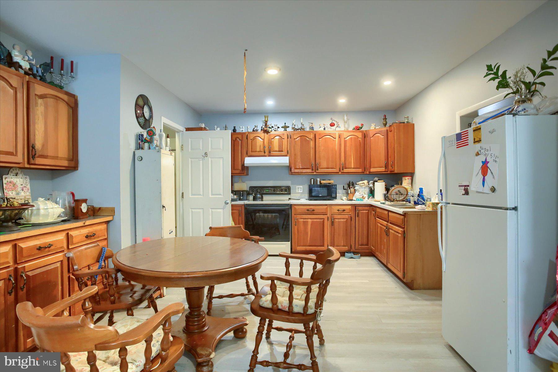 46 Front Street New Buffalo, PA 17069 - Photo 8 of 28 a kitchen with stainless steel appliances kitchen island granite countertop a refrigerator and a stove top oven