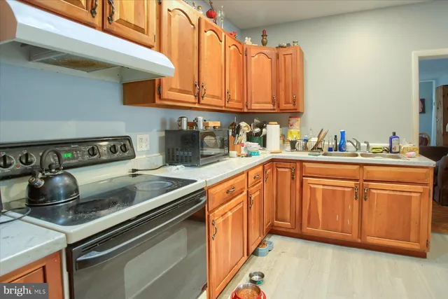 a kitchen with stainless steel appliances granite countertop a sink stove and cabinets