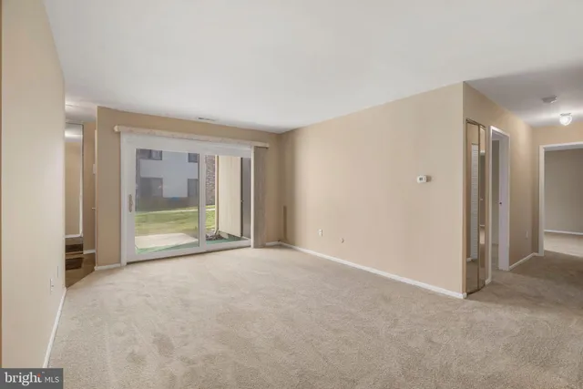 a view of an empty room with glass door