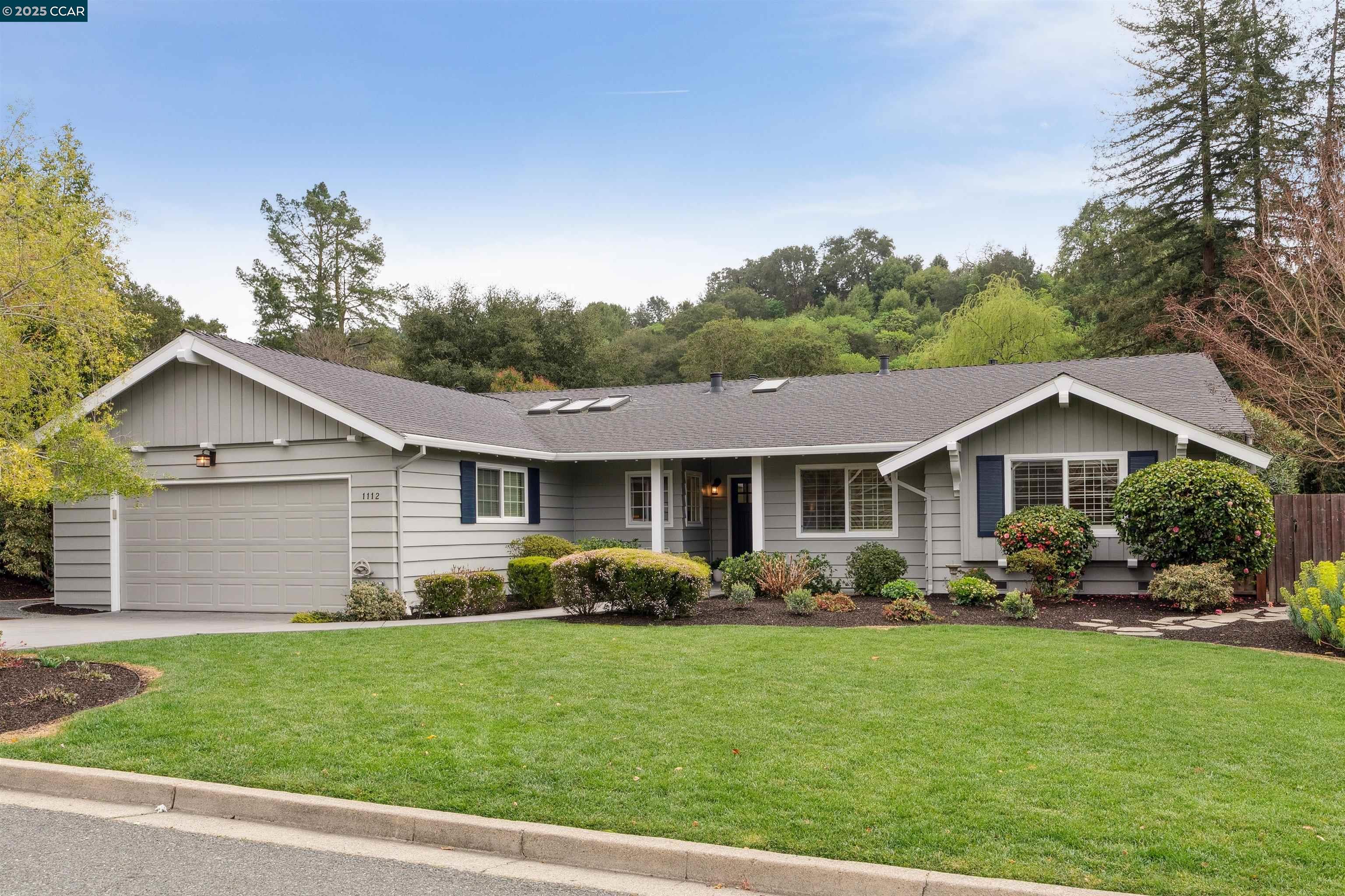 a front view of house with yard and green space