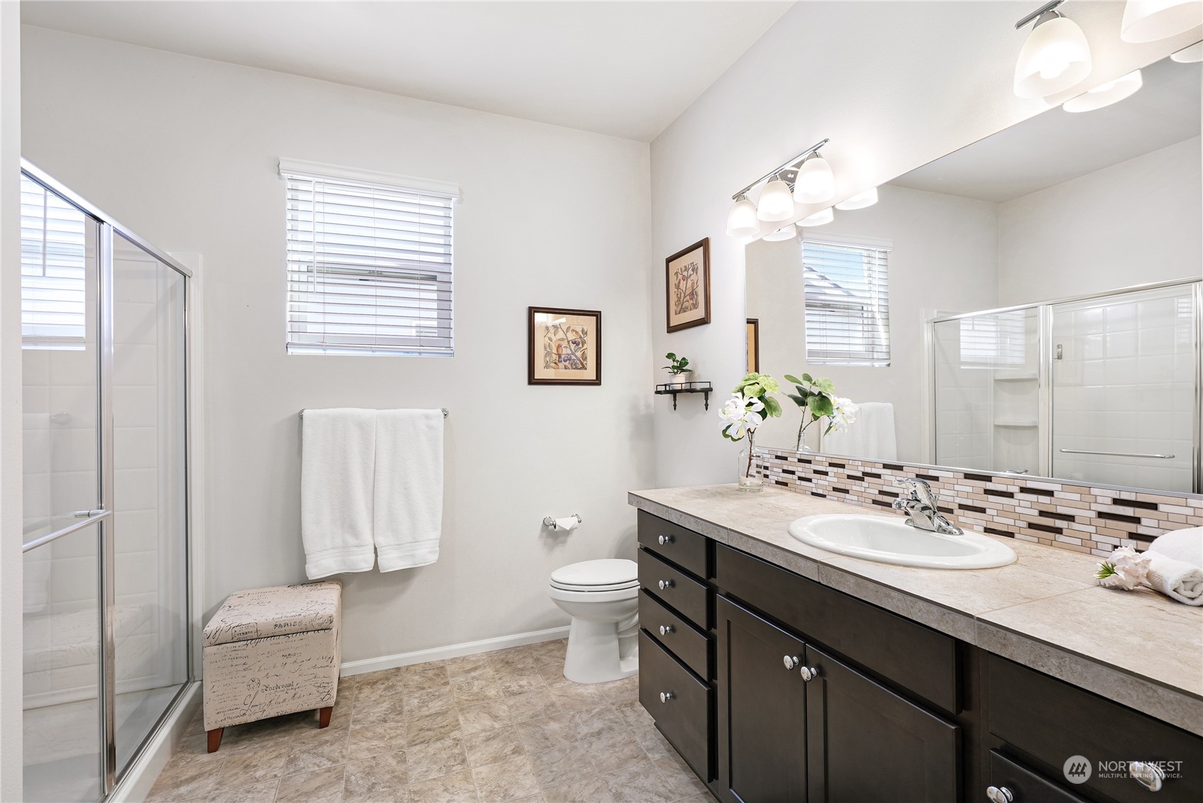 832 Maple Lane Southwest, Unit 59 Orting, WA 98360 - Photo 15 of 32 a bathroom with a sink double vanity and a mirror