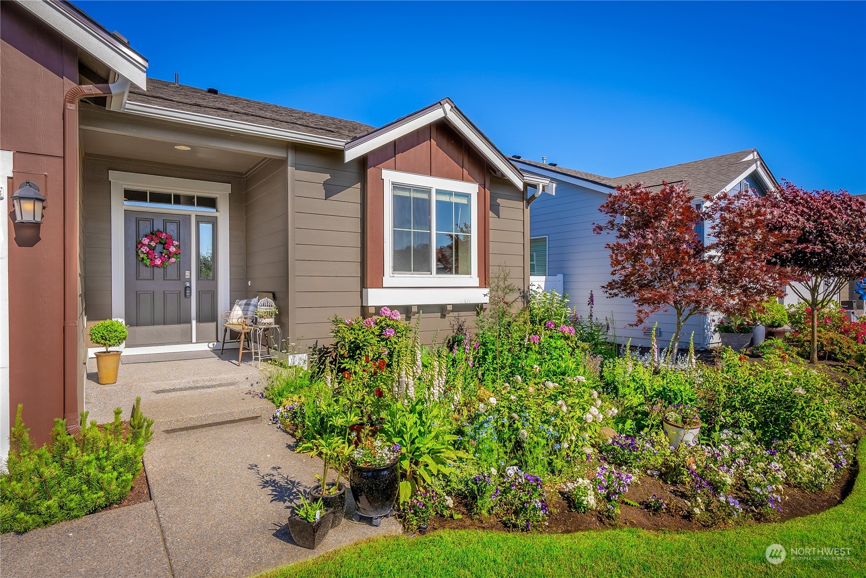 832 Maple Lane Southwest, Unit 59 Orting, WA 98360 - Photo 3 of 32 a front view of a house with a yard