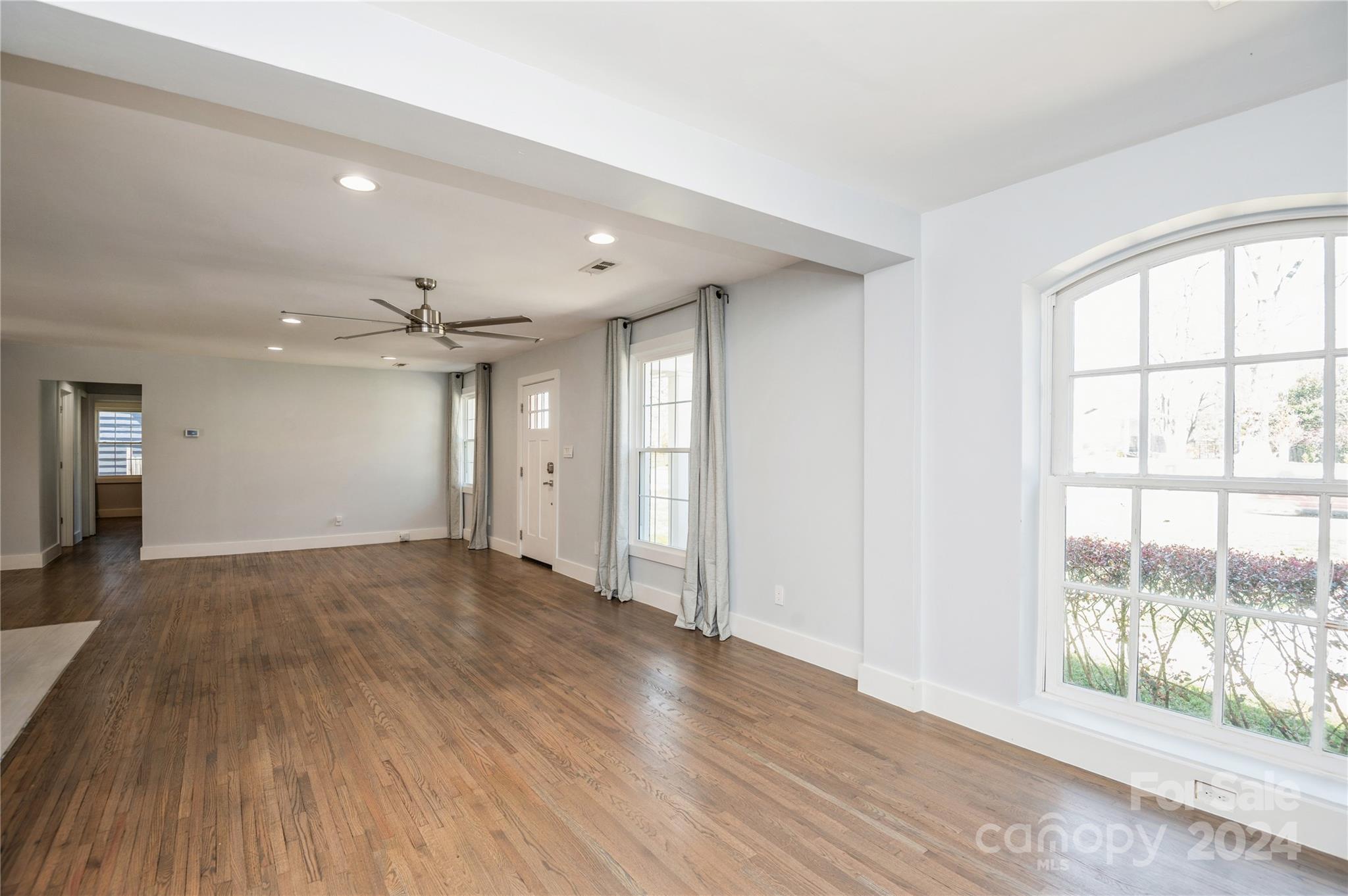2124 Tyvola Road Charlotte, NC 28210 - Photo 13 of 38 a view of an empty room with wooden floor and a window