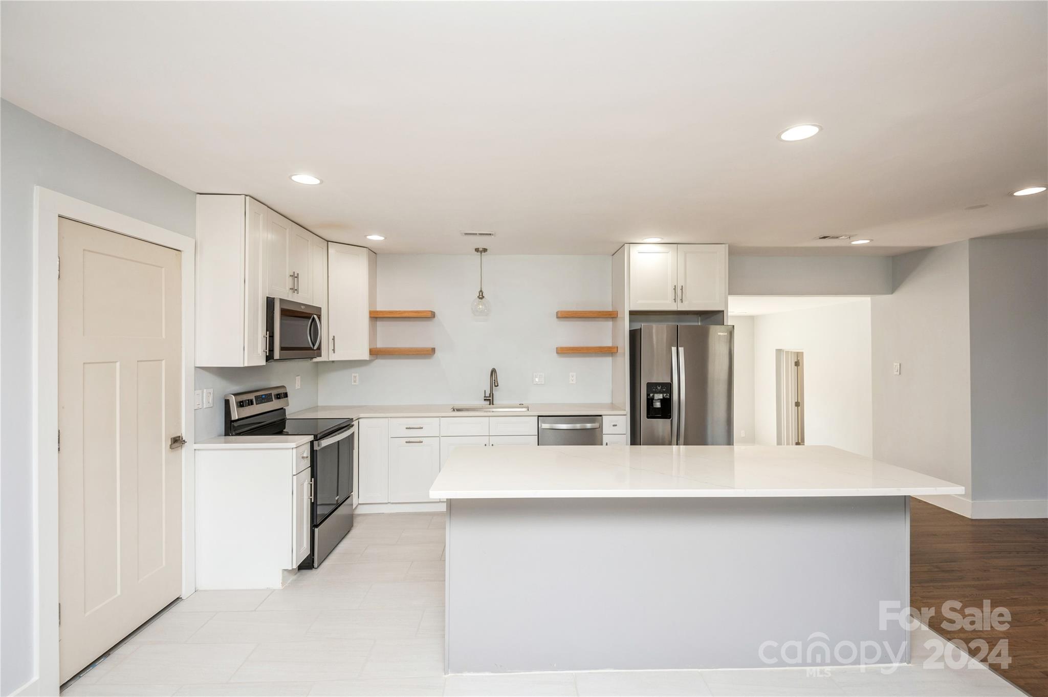 2124 Tyvola Road Charlotte, NC 28210 - Photo 14 of 38 a kitchen with stainless steel appliances granite countertop a sink refrigerator and microwave