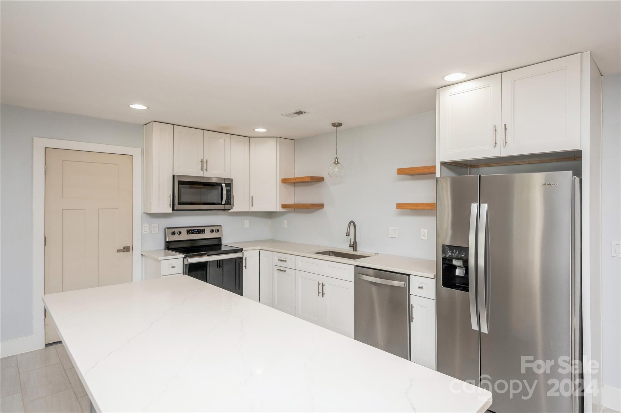 2124 Tyvola Road Charlotte, NC 28210 - Photo 15 of 38 a kitchen with stainless steel appliances a refrigerator stove microwave and cabinets