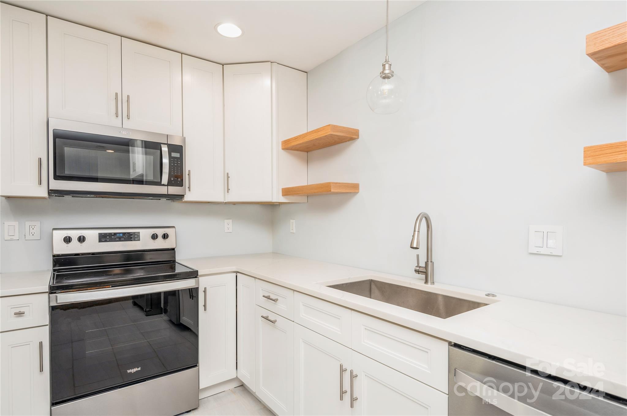 2124 Tyvola Road Charlotte, NC 28210 - Photo 17 of 38 a kitchen with stainless steel appliances a stove a microwave and cabinets