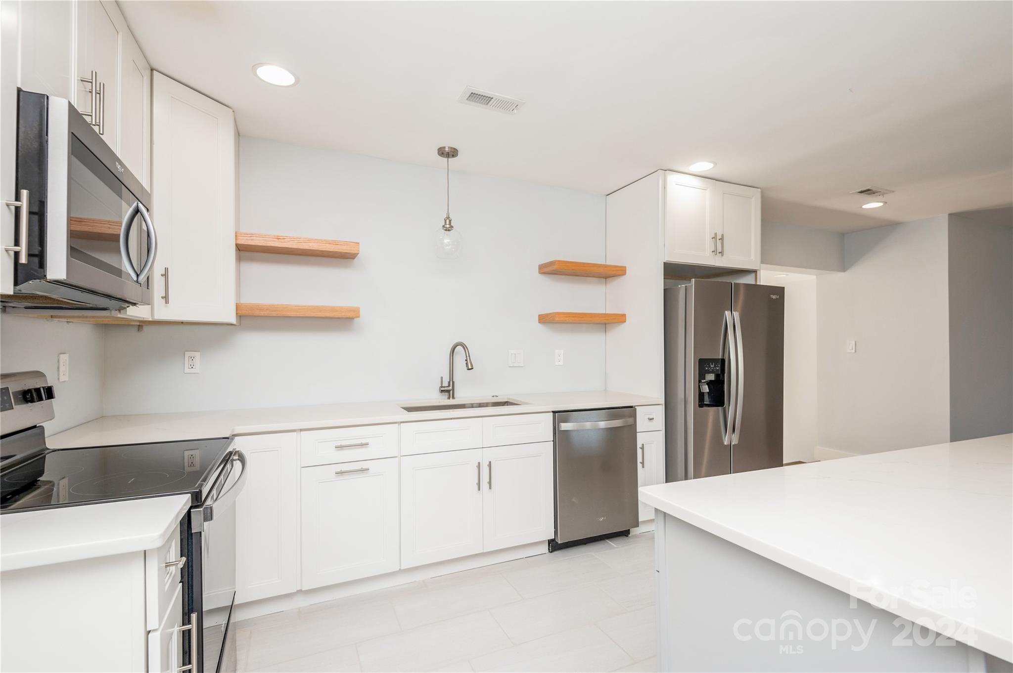 2124 Tyvola Road Charlotte, NC 28210 - Photo 18 of 38 a kitchen with stainless steel appliances a sink a stove a refrigerator and cabinets
