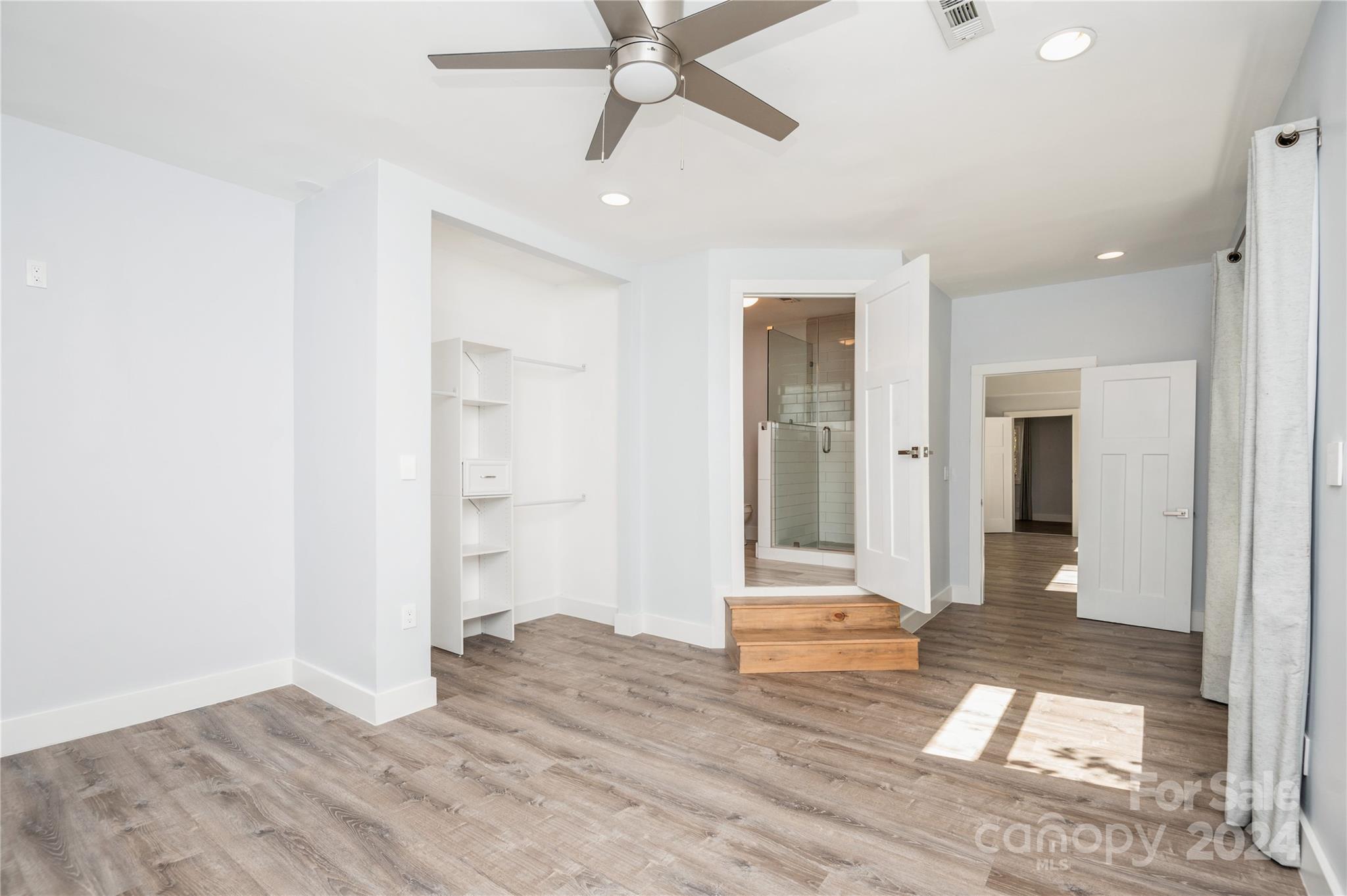 2124 Tyvola Road Charlotte, NC 28210 - Photo 21 of 38 wooden floor in an empty room with a window