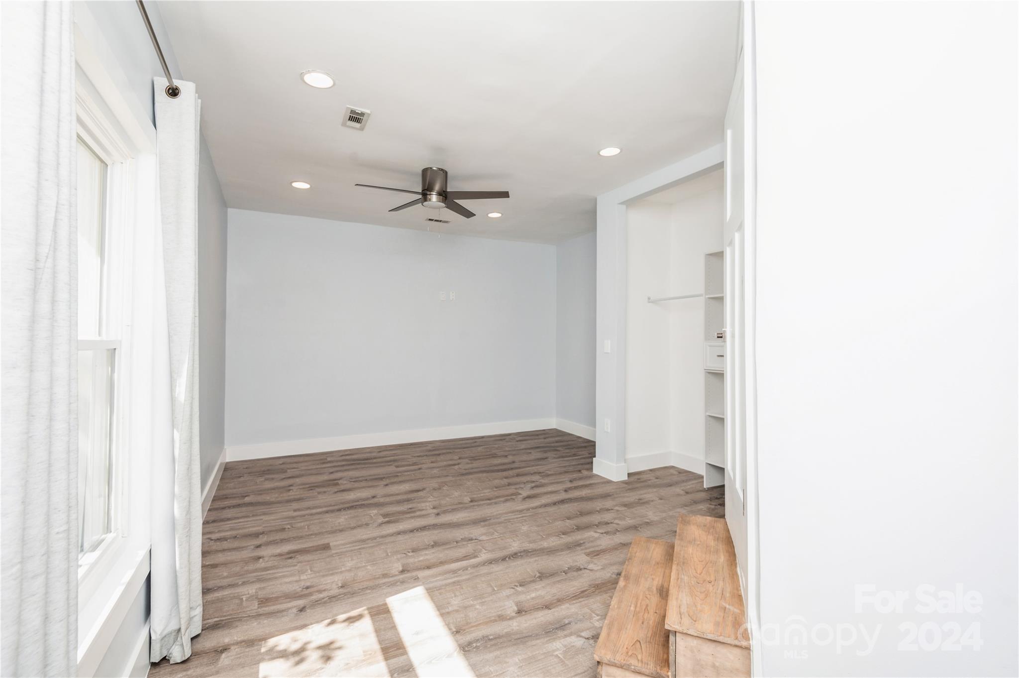 2124 Tyvola Road Charlotte, NC 28210 - Photo 22 of 38 a view of a hallway with a chandelier fan