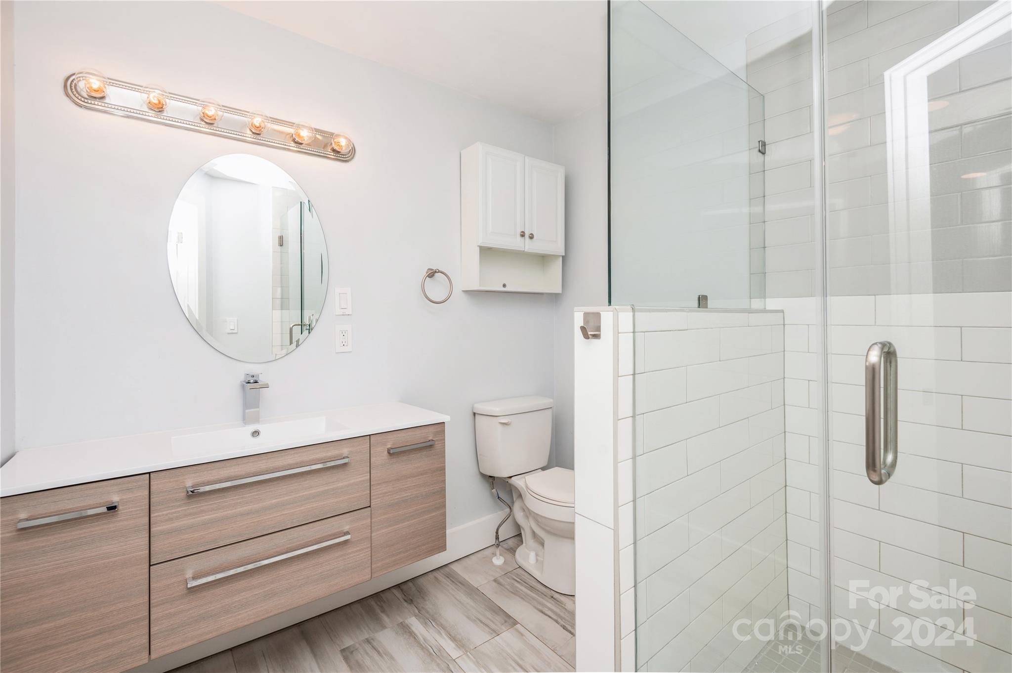 2124 Tyvola Road Charlotte, NC 28210 - Photo 23 of 38 a bathroom with a toilet sink and mirror