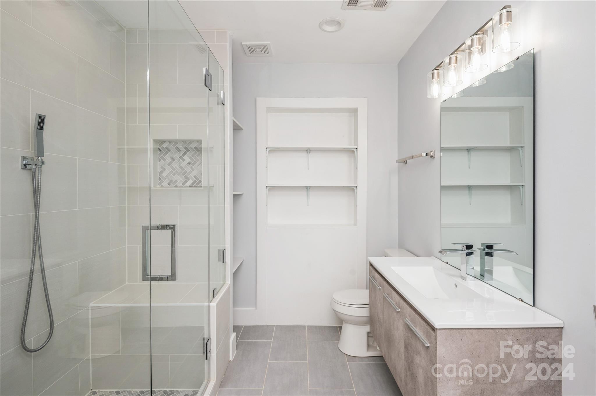 2124 Tyvola Road Charlotte, NC 28210 - Photo 28 of 38 a bathroom with a sink toilet and shower