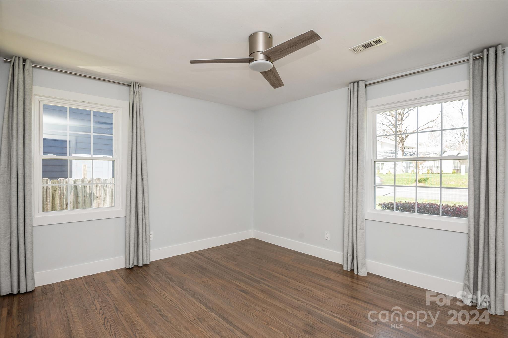 2124 Tyvola Road Charlotte, NC 28210 - Photo 29 of 38 an empty room with wooden floor cabinet and windows