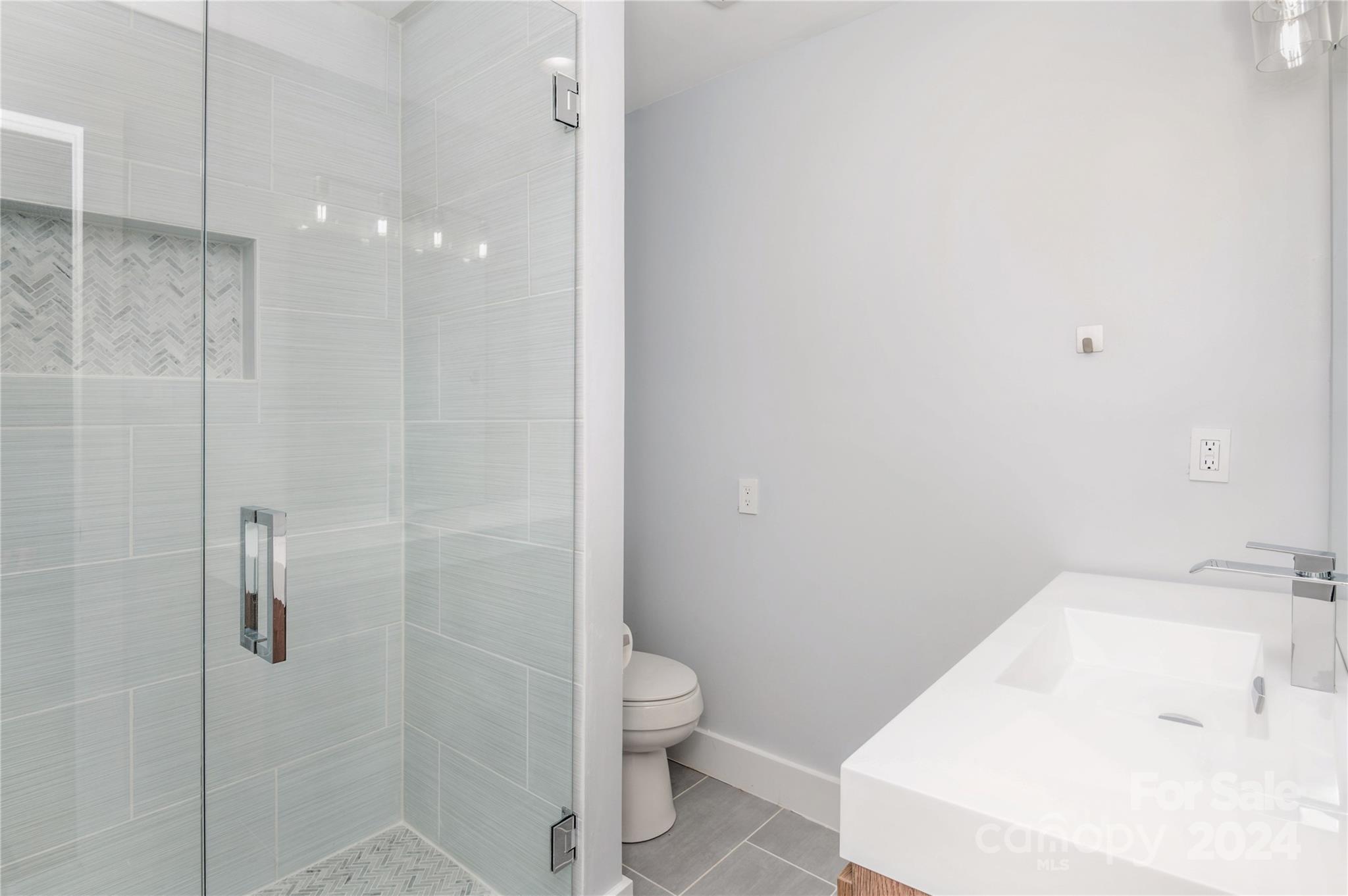 2124 Tyvola Road Charlotte, NC 28210 - Photo 31 of 38 a bathroom with a sink a toilet and shower